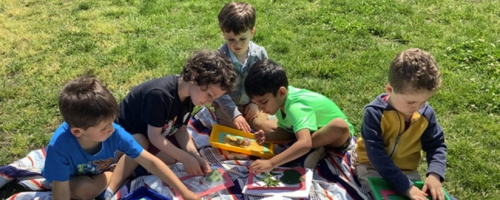 Children outside creating leaf paintings