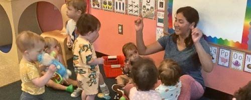 Preschool teacher engaging a group of toddlers