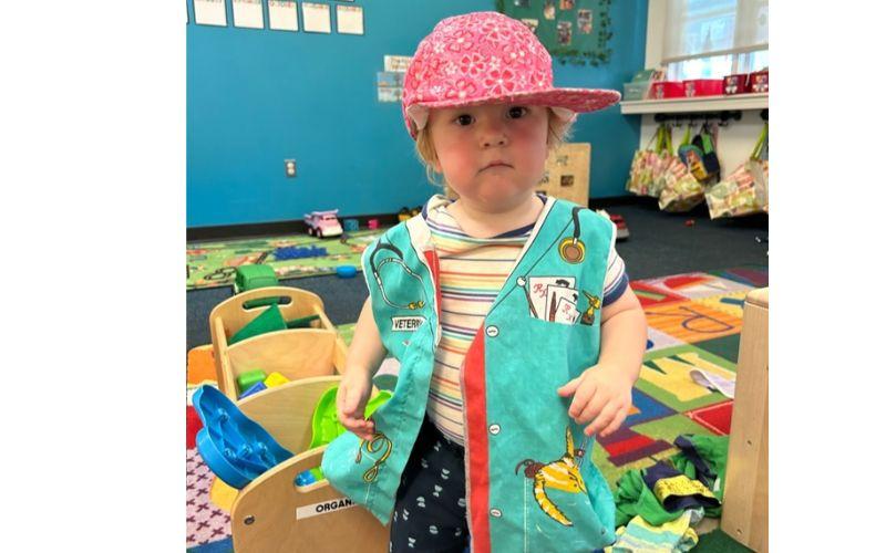 Toddler dressed up as a veterinarian in preschool